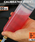 Hand holding 200cc Fluid Extractor Syringe Oil Pump With 23 Inch Flexible Hose, metric measurements visible on syringe