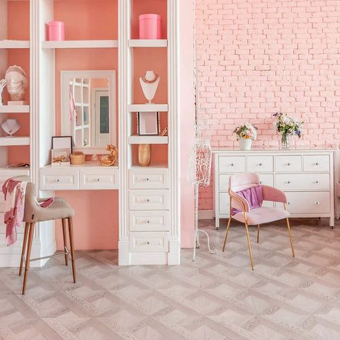 Stylish pink and white dressing room with modern decor and sleek storage solutions, featuring elegant furniture and floral accents.
