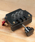 Pro Grade Self Centering Doweling Jig Kit with Anodized Finish placed on wood surface showcasing alignment guides and drill bits.