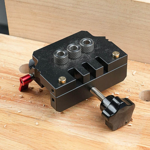 Pro Grade Self Centering Doweling Jig Kit with Anodized Finish placed on wood surface showcasing alignment guides and drill bits.