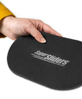Person holding an XL oval felt furniture slider for hard surfaces, reusable anti-slip moving pad, set of 4, protects hardwood floors.