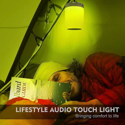 Person reading in tent with Go-To Smart Touch Bedside Lamp With Bluetooth Speaker Dimmable Color Night Light hanging above.