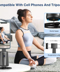 Woman practicing yoga next to Face Tracking Tripod With 360 Degree Real Time Rotation For Smartphones No App Needed Remote Control And Gesture Sensing Rechargeable Smart Phone Stand For Live Streaming TikTok Photos And Videos Black with phone attached.