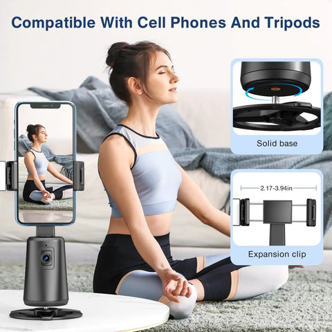 Woman practicing yoga next to Face Tracking Tripod With 360 Degree Real Time Rotation For Smartphones No App Needed Remote Control And Gesture Sensing Rechargeable Smart Phone Stand For Live Streaming TikTok Photos And Videos Black with phone attached.