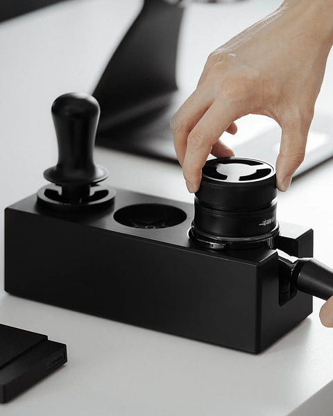Hand placing distributor in Walnut 4 In 1 Espresso Knock Box And Tamping Station With Portafilter Holder Tamper Holder And Distributor Holder For 51 To 54 Mm Espresso Gear Keeps Your Coffee Station Neat And Dope For Home Baristas And Small Cafes