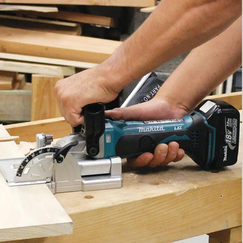 Man using 18V LXT Cordless Plate Joiner with Rack and Pinion Fence Aluminum Pivot Fence for precise woodworking biscuit joints