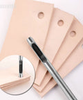 Close-up of a punch creating clean holes in tan leather, part of a 6 Piece Hollow Leather Hole Punch Set For Belts And Watch Bands.