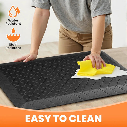 Extra Thick Four Fifths Inch Non Slip Anti Fatigue Kitchen Floor Mat Waterproof Stain Resistant Cushioned Comfort Mat For Standing And Office Use 17 By 24 Inches Black being cleaned with a cloth on a countertop