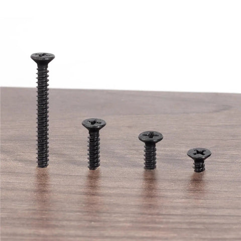 Five Piece Set Black Stainless Steel Phillips Head Self Tapping Wood Screws 4x40mm displayed on wooden surface