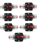 Assorted resettable 100 amp fuse circuit breakers for car audio systems, 12 to 24V DC, various amp ratings, black and red design.