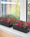 Get Your Garden Game On Point With This Set Of Two Deck Railing Planter Boxes That Clip Over Fence Rails Packed With Six Tough Plastic Flower Pots To Make Growing Herbs Veggies Or Blooms An Absolute Breeze For Chill Weekends And Easy Peasy Garden Vibes. Two black planter boxes filled with colorful blooms on a windowsill.