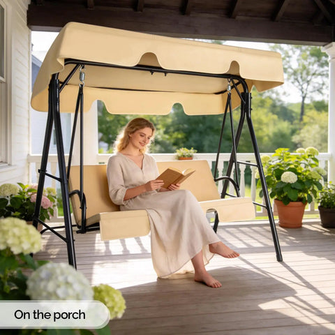 Outdoor Porch Swing With Adjustable Canopy And Heavy Duty Stand, beige cushions, woman reading on porch glider.
