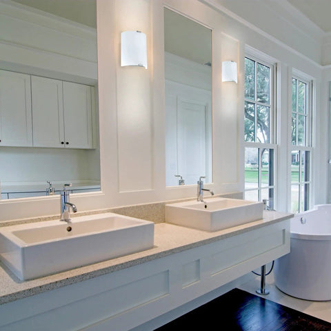 Slick Modern 1 Light Vanity Wall Sconce with Dimmable LED, milky glass front, silver accents, in a bathroom setting.