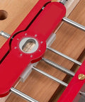 Close-up of Top Shelf Mortise Tenon Jig For Woodworking With Self Centering Dowel Guide and Punch Locator on wood surface.