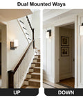 Modern Matte Black Wall Sconces Set Of Two Double Clear Glass Vanity Lights with upward and downward mounting showcased in a hallway.