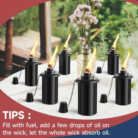 Citronella Outdoor Torches Set of 6 with 16 Ounce Fuel, 58 Inch Black Garden Lanterns on a table with wicks burning