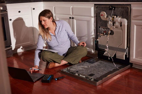 Woman using Mahi Driver Kit All In One One Quarter Inch Aluminum Bit Driver With Swivel Top Knurled Grip Forty Eight Steel Bits for appliance repair