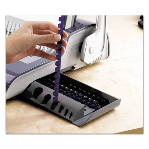 Dead Simple Desktop Comb Binding Machine That Crushes 25 Sheets Fast, inserting purple comb binding into unit.