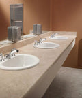 Commercial M Dura Widespread Lavatory Faucet 2.2 GPM Chrome Finish Solid Brass in public restroom sink setup