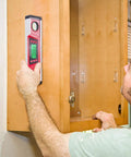 Person using 10 Inch Digital Level and Protractor with IP54 Inclinometer, Large LED Backlight Display on wooden cabinet