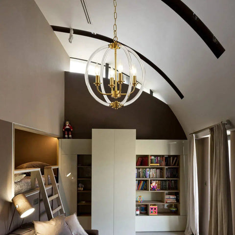 Modern Four Light Pendant Chandelier with clear acrylic globes and brass finish in dope farmhouse style in a stylish living room.