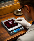 Man using Pocket Digital Kitchen Scale For Jewelry And Cooking, 500g Capacity With 0.01g Precision, measuring gemstone weights.