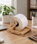 Solid Wood Label Holder And Sticker Dispenser for Roll Labels on desk beside laptop and plant