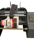 Hustle Ready Semi Automatic Label Applicator For Cylindrical Bottles Cans Jars And Tubes With No Sweat Setup And Smooth Operation Up To 1200 Per Hour For Production Lines with a cylindrical bottle in operation.