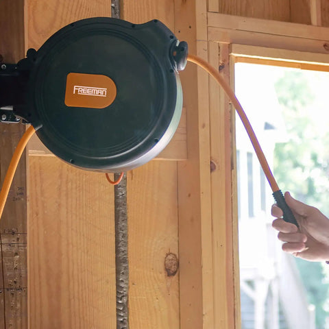Mounted compact retractable air hose reel with brass fittings and mounting bracket, visible 1/4 inch by 65 feet hybrid PVC hose.