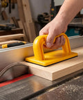 Built Tough Woodshop Push Handle Safety Guide Block With Reinforced Frame And Grippy Bottom For Steady Feed Control On Table Jointers And Thickness Planers in use on a table saw.