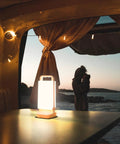 Solar Camping Lantern With 6000mAh Rechargeable Battery Up To 80 Hours Of Light illuminating a camper van table at dusk