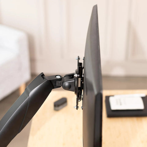 Hassle Free Quick Release VESA Mount Adapter Bracket Kit With Removable Plate For LCD Monitors And TV Screens attached to a TV arm.