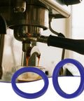 2 Pack Silicone Group Head Gaskets For E61 Espresso Machines Group Heads And Portafilters 8.5mm Blue Durable BPA Free High Temperature Resistant Easy Swap For Quick Replacements visible near espresso machine.