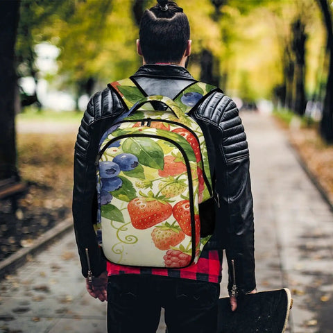 Man wearing Mixed Berry Vine Watercolor Printed Unisex Backpack Large Capacity Durable Polyester Breathable Design With Sturdy Zipper Ideal For School Work Travel And Everyday Carry while holding skateboard on tree-lined path