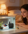 Quiet 25W Submersible Fountain Pump With 400 GPH Flow For Pond And Aquarium Filtration in a fish tank with a smiling woman.