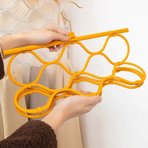 Foldable Scarf Organizer Rack With 18 Slots For Closet Storage And Necktie Display held up in hands, bright orange durable design.