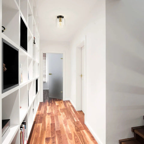 Polly 1 Light Flush Mount Ceiling Light With Black Finish, Clear Glass Shade, Antique Brass Socket in modern hallway.