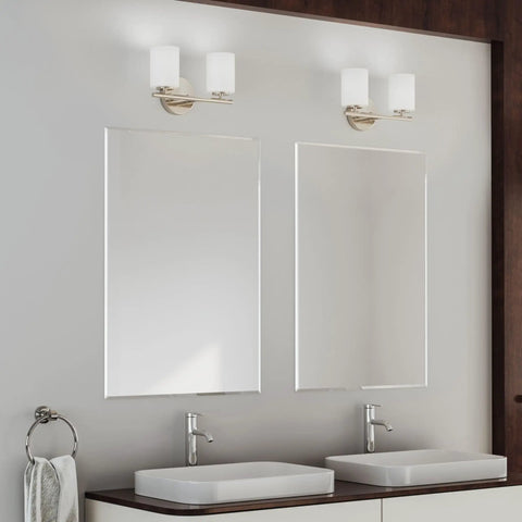 Two Light Etched White Glass Modern Bath Vanity Light In Brushed Nickel Finish above double sinks, mirrors in bathroom.