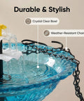 Close-up of solar bird bath fountain with hanging cascade water bowl and pump, featuring blue crystal clear bowl and weather-resistant chains.