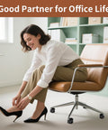 Woman sitting on brown office chair, adjusting shoes. Office chair on caster wheels suitable for 5 Pack Office Chair Wheel Stoppers Cushioned Caster Cups With Felt Bottom Pads For Hardwood Floors And Carpets To Prevent Scratches, Universal Fit For Most Chairs, Black.