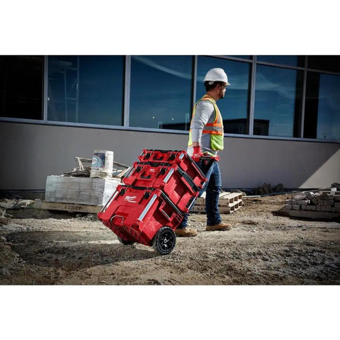 Worker using Packout 22 Inch Tool Box With Heavy Duty Latches And Interior Organizer Trays Durable Modular Storage System on job site.