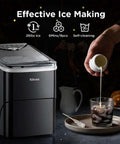 Silonn countertop ice maker, black finish with clear lid; front view beside glass and ice scoop