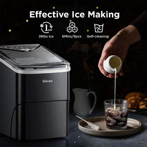 Silonn countertop ice maker, black finish with clear lid; front view beside glass and ice scoop
