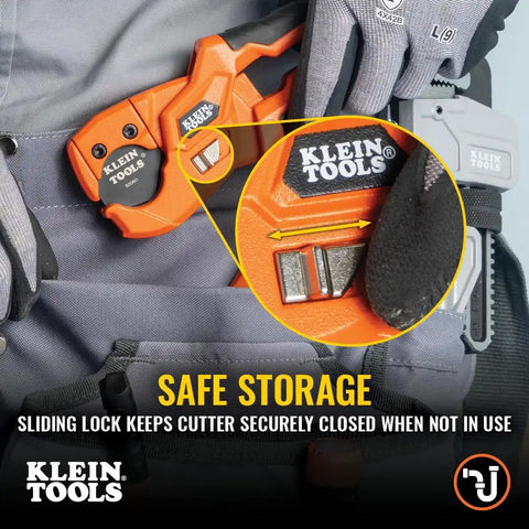 Lightweight PEX Pipe And Tubing Cutter with soft molded handles and pierce point blade secured on a belt for easy storage.