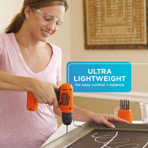 Woman using Ultra Lightweight 8V Max Cordless Drill Driver For Home DIY with keyless chuck on a chalkboard in home setting.