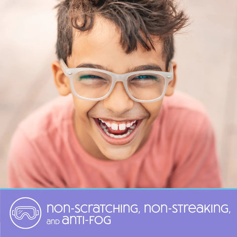 Front view of a smiling boy wearing white-framed eyeglasses; purple banner with anti-fog text.