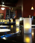 Rechargeable Tealights Flickering Flameless Candles With Charging Base And AC Adapter 12 Pack LED Tealight Set on restaurant table