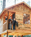Children on a treehouse preparing for a ride on a 200 Ft Zip Line Kit with Adjustable Harness and Bungee Brake System for Backyard Fun.