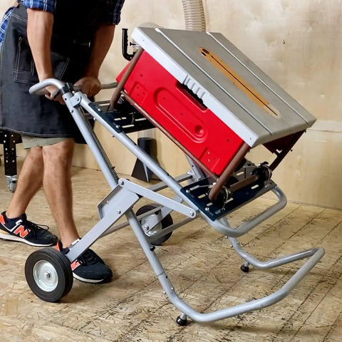 Foldable Table Saw Stand With Wheels For On The Go Mobility And Storage 330 Lbs Load Capacity Portable Universal Fit For Most Saws Sturdy On Any Jobsite Easy Roll Locking Wheels For Garage, shown in use with a table saw being tilted.