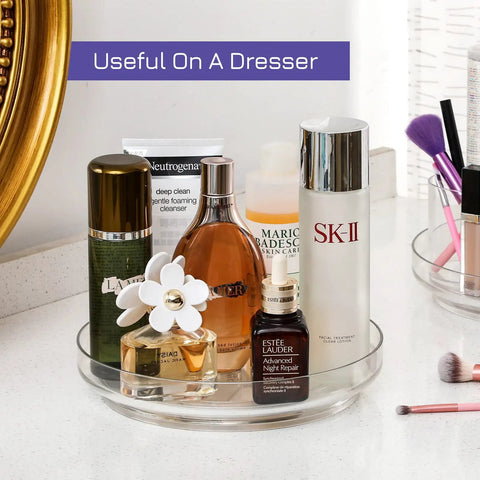 Four Pack 9 Inch Clear Acrylic Lazy Susans Non Skid Turntables Organizer with cosmetics on vanity countertop.